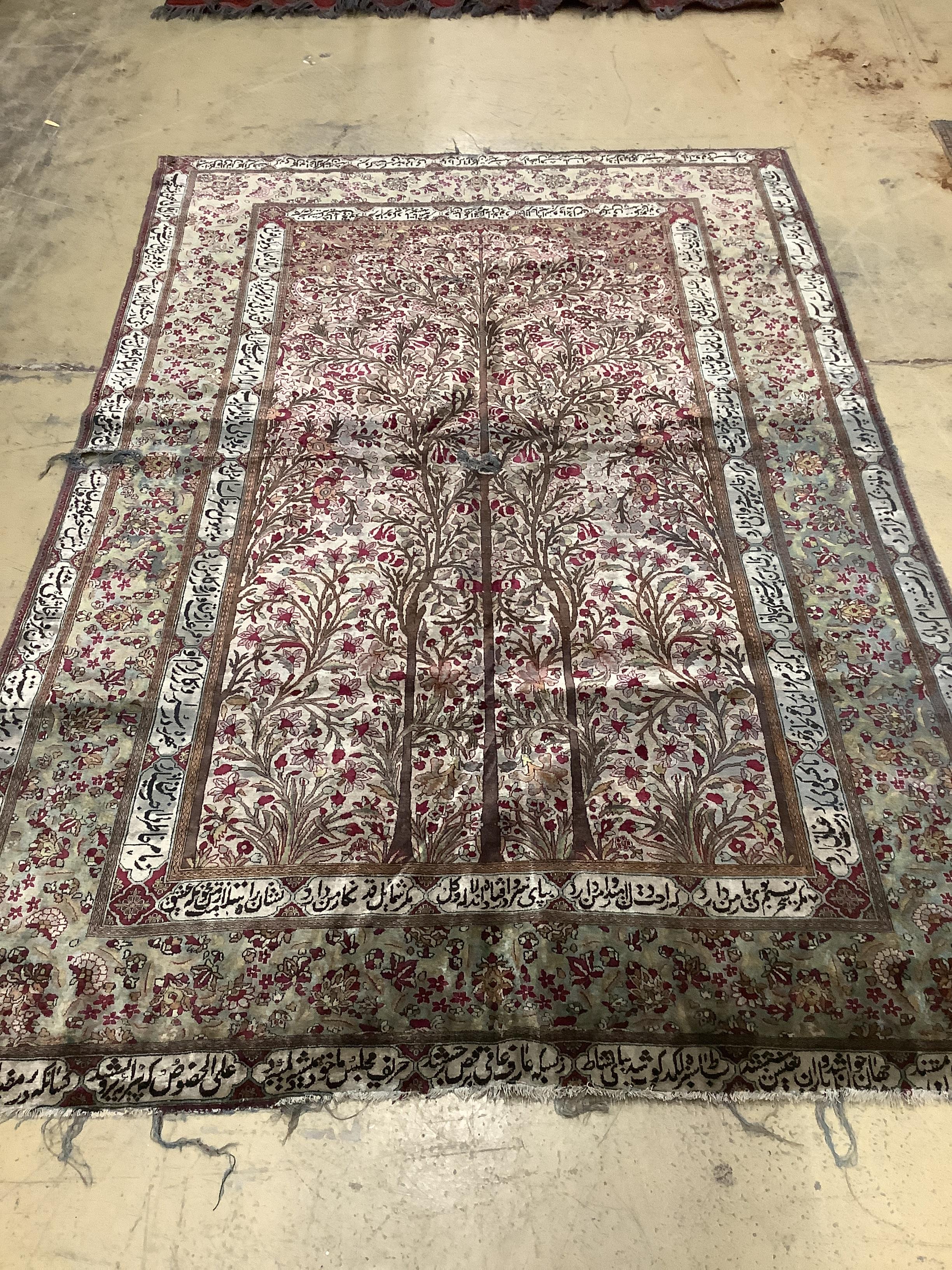 An antique Tabriz part silk rug, holed and worn, 198 x 136cm